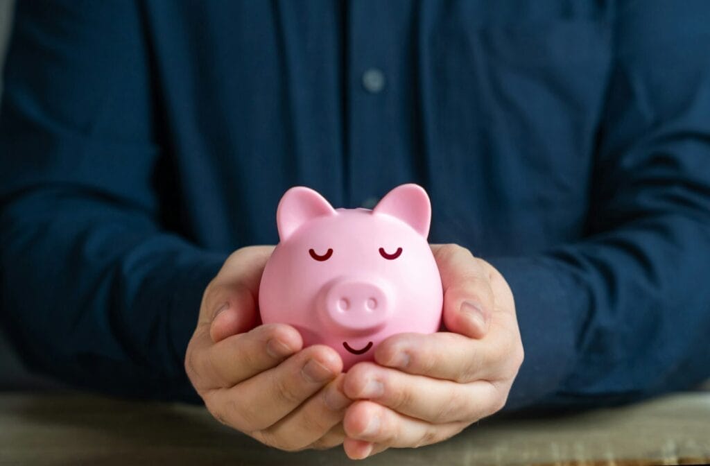 A calmly sleeping piggy bank in the hands.