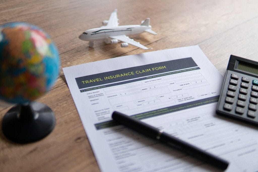 Selective focus image of travel insurance claim form on a wooden table.